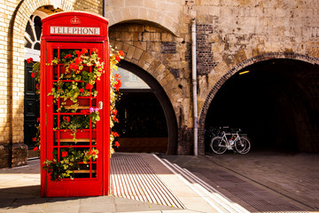 Traditional english telephone box with flowers. Bath, England, UK. - obrazy, fototapety, plakaty