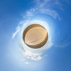 Little planet transformation of spherical panorama 360 degrees. Spherical abstract aerial view in field with awesome beautiful clouds. Curvature of space.