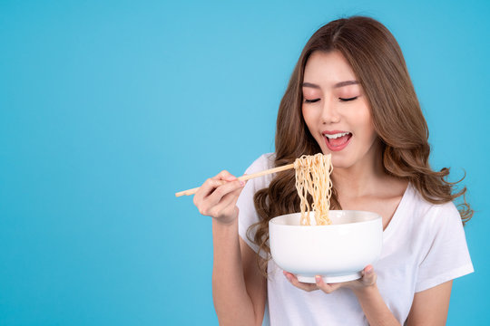 Portrait Of Happy Smiling Young Asian Woman Eating Asian Noodle