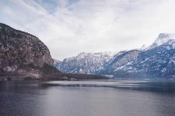 white snow rock mountain and valley scenic area of Hallstatt village tourism attraction site, Austria, Europe during winter low season. Blue light tone calm and cool mood for banner and background.
