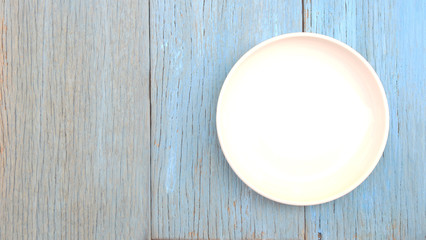 white plate on wood table background