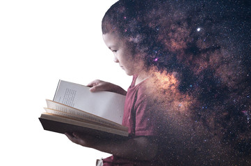 The double exposure image of the boy reading a book overlay with the milky way galaxy image. the concept of imagination, technology, future, and gaming.