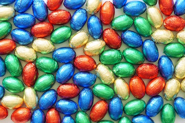 Close-up of pile of colorful candy Easter eggs wrapped in colored foil. colorful candies