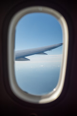 Fototapeta na wymiar Wings of airplane seen through passanger window