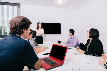 Group of office workers at a meeting around the boss