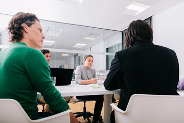 Group of office workers at a meeting around the boss