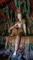 Fototapeta na wymiar Supreme wood carving of bodhisatta statue. Avalokitesvara sculpture. Finest chinese art at Shuanglin Temple (or Zhongdu Temple), outskirts Pingyao Old City, Shanxi province, China