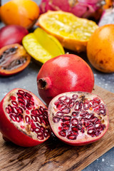 Pomegranate Tropical Fruit Cut in Half on Wooden Board