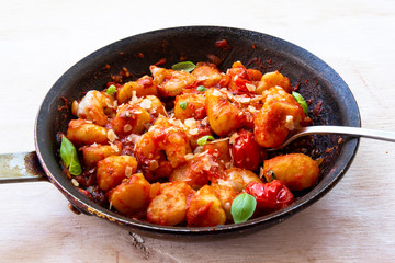 Gnocchi with tomato sauce and garnshied basil and cheese