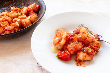 Gnocchi with tomato sauce and garnshied basil and cheese