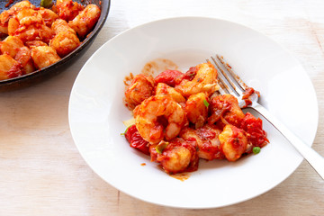 Gnocchi with tomato sauce and garnshied basil and cheese