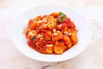 Gnocchi with tomato sauce and garnshied basil and cheese