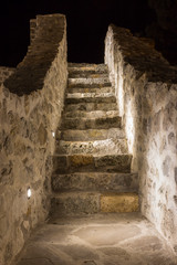 Inside view of the beautifully lit ancient fortress with reconstructed walls and stairs