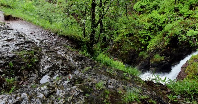 Picturesque landscape of a mountain river with traditional nature of Scotland. 4K Footage.