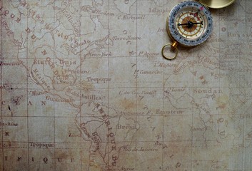 Fototapeta na wymiar old compass on wooden background