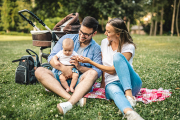Happy young family enjoying together in park.