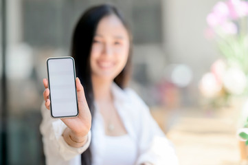 woman showing blank screen of smartphone.
