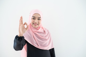 Half length portrait of asian beautiful Muslim young woman wearing business attire and hijab with mixed poses and gestures isolated on grey background. Suitable for technology, business finance theme.