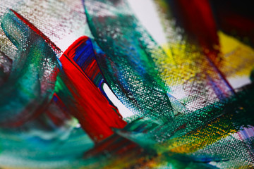 Close-up view of mixed colours on canvas. Chaos illustrated on painting. Fragment of artwork. Oil...
