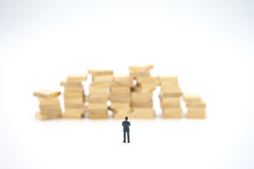 Miniature people standing on stack of wood Investment Analysis Or big data Analysis. as background business concept ,big data concept and Money, Financial, Business Growth concept with copy space.