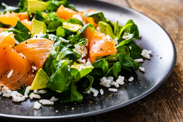 Salmon salad - smoked salmon white rice and vegetables on wooden table