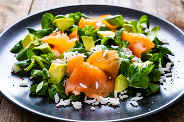 Salmon salad - smoked salmon white rice and vegetables on wooden table