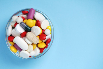 A bowl with colorful medicine pills	