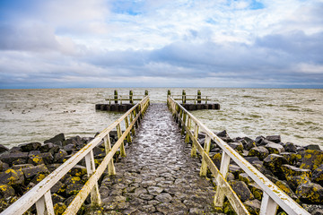 Stone pier by the Vlietermonument near Den Oever in Netherlands