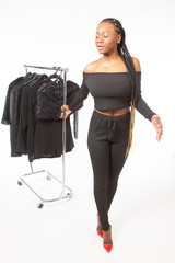 Black leather model. Girl in a clothing store. Concept - African