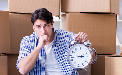 Young man moving in to new house with boxes