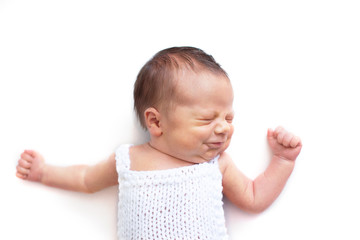 Newborn baby emotions, white background. Funny face of a child, emotions.