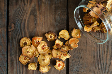Dried pear from glass can on wooden background