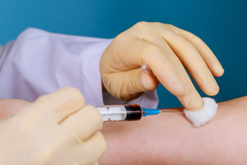 Close up blood test from vein with medical technologist doing a blood draw services