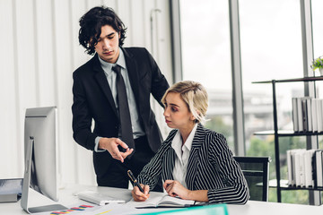 Successful of two casual business team meeting and discussing strategy with new startup idea project.Creative business woman planning and write on book and looking at desktop computer in modern office