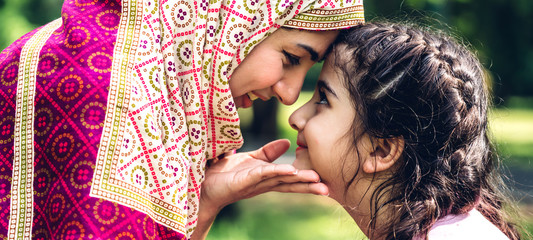 Portrait of religious enjoy happy love asian family arabic muslim mother and little muslim girls...