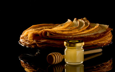 Shrovetide Maslenitsa Butter Week festival meal. Stack of russian pancake blini on a dark rustic...