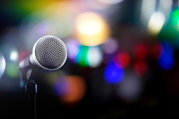 Microphone on a black background with colorful lights and flares