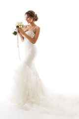 Fototapeta na wymiar Wedding Bride, Beautiful Woman in White Dress with Flowers Bouquet, Elegant Studio Portrait