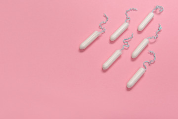 Group of tampons seen from a high angle view on a pink background with space for copy