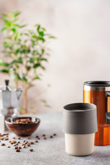 Reusable coffee mug  on a bright background. Healthy break. Reusable ware. Zero waste concept