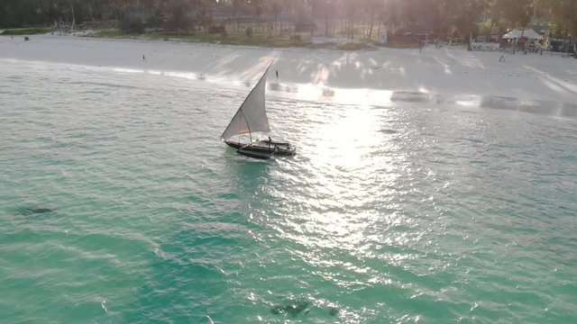 Traditional African Sailboat at Zanzibar island Paje beach in blue Indian ocean aerial view. Unguja, tanzania