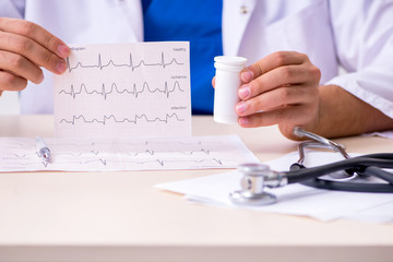 Young male doctor cardiologist working in the clinic