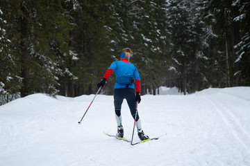 Fototapeta na wymiar Skiing in the winter forest. Winter leisure and recreation. Cross country Skilling.