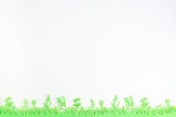 Yellow paper texture with green felt grass, Easter background in pastel colors, horizontal, copy space