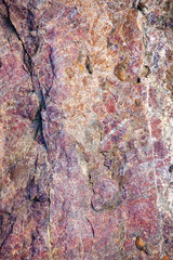 Orange red purple texture of large stone suitable as background