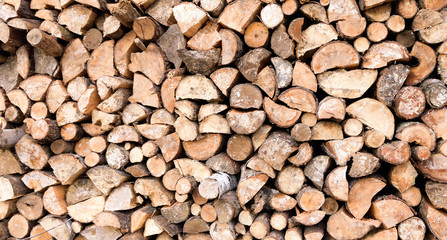 Large rural stack of firewood. Old firewood. Background.