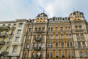 A row of old buildings captured during the golden hour in Kiev, Ukraine. Buildings have different colors, with detailed and ornate facade. Big city life.