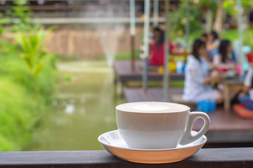 Coffee Mugs white plate with The heart shaped makeup on  iron balconies  Background Lotus pond.