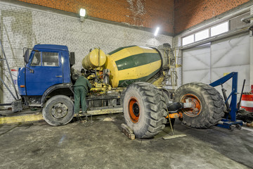 Fototapeta premium Concrete mixer machine in a repair shop.