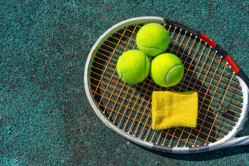 Tennis balls lie on a racket